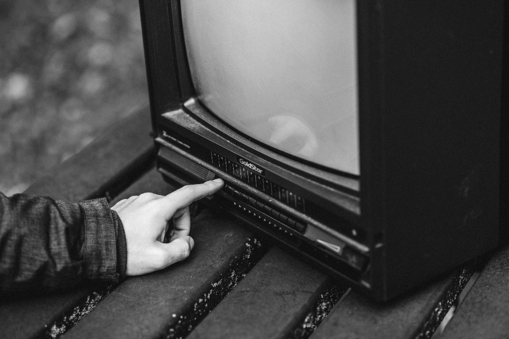 GoldStar CRT television, hand on the channel button, monochrome